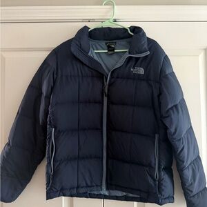 The North Face Blue Puffer Jacket with High Collar and Full-Length Zipper